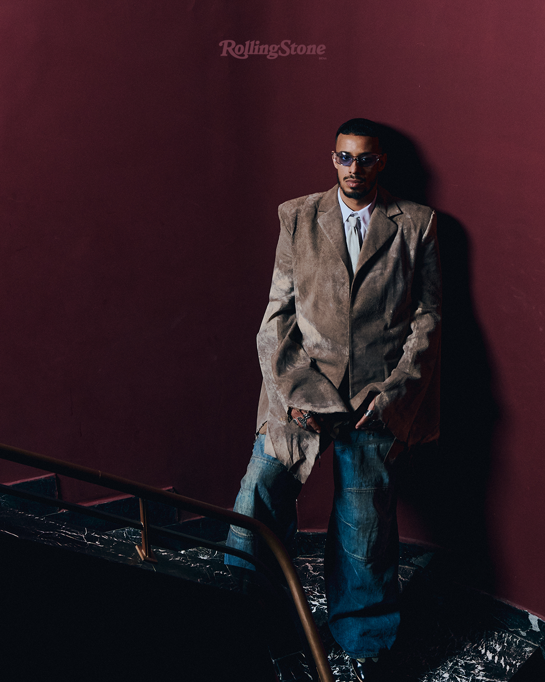 Photography by Loubet; Creative Direction by Aymane Ait Haddouch; Styling by Nathalie Sicart; Stormy wears jacket by Nonkonform, shirt and shoes by Niccolò Pasqualetti (Karla Otto), tie by Moohong (Autrement PR), pants by G-Star (LEDE), belt by Lueder (Reference Studios), sunglasses by Casablanca (Radical PR), and jewelry by Aneida Jewelry and Dyskinesiaa.